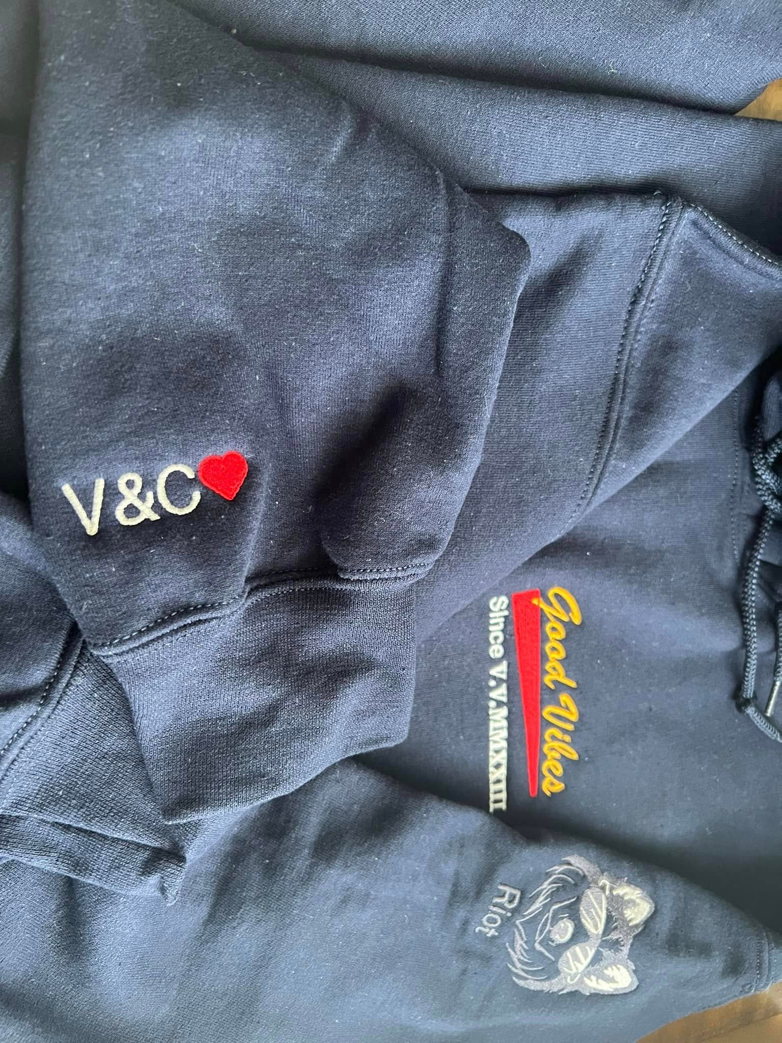 custom embroidery logo and a initials on a left chest and sleeves of a hoodie